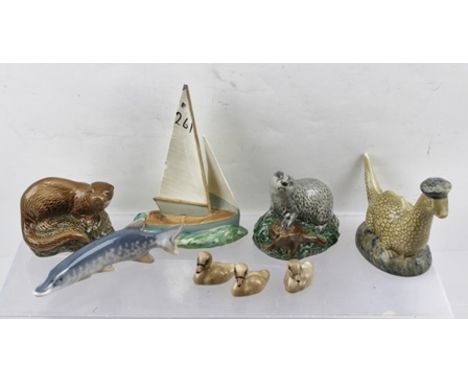 A BESWICK EARTHENWARE BENEAGLES SCOTCH WHISKY "LOCH NESS MONSTER" (no contents) and an "OTTER" (no contents), together with a