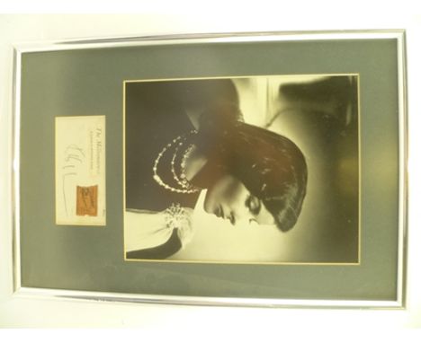 KATHERINE HEPBURN A black and white studio portrait, mounted with an autograph, possibly a page from a book, in which someone