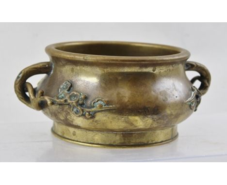 A BELIEVED 18TH CENTURY CHINESE CENSER with unusual cast spring blossom handles, on squat globular form with plain flared foo