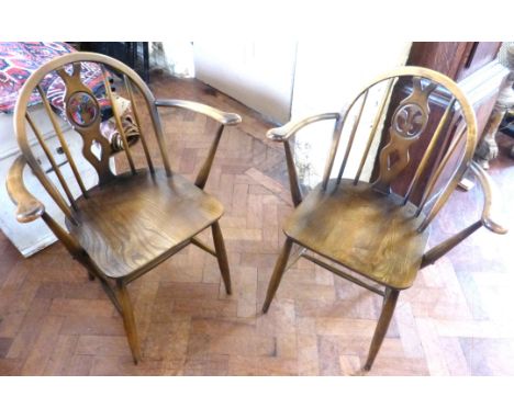 Pair of Ercol elbow chairs.