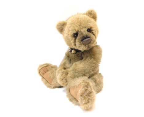 A Charlie Bears light brown bear, with bell collar, bearing label, 43cm high. 