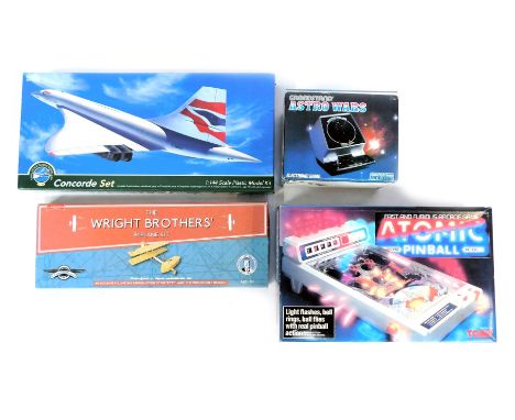 Models and games, comprising The Wright Brothers bi-plane kit, 1:144 scale Concorde Set, Grand Stand Astro Wars and Tomy Atom