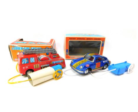 An Asahi battery operated remote control tinplate ladder fire engine, with top light and siren, and a Yone battery operated r