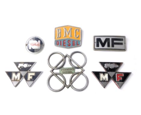 A collection of automobile badges, to include MF, Norton, BMC Diesel, Perkins Diesel, etc. (1 box) 