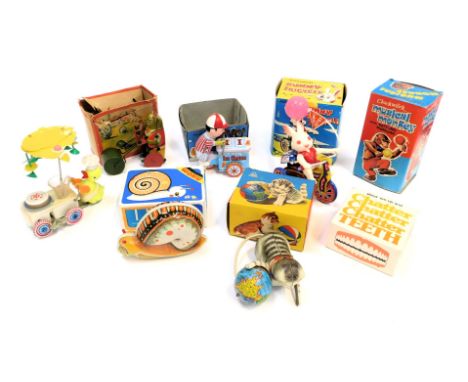 A group of clockwork tinplate toys, to include snail, cat and ball, talking teeth, cat mowing the lawn, musical monkey, bunny