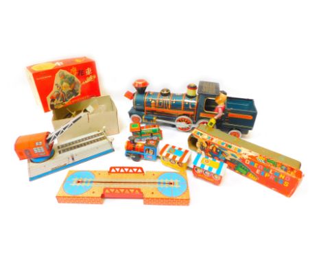 Tin plate toys, comprising a tinplate locomotive for the Frontier 3673, a Dreamland Express wind up engine and bridge, tinpla