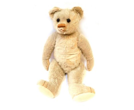 A 1940s plush blonde jointed Teddy bear, in light coloured fur, with wire wool filling, 63cm high. 