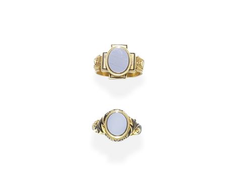 TWO GOLD, ENAMEL AND SARDONYX MEMORIAL RINGS, DATED 1865 AND 18721st: 1865, The oval sardonyx plaque, within a foliate mount 