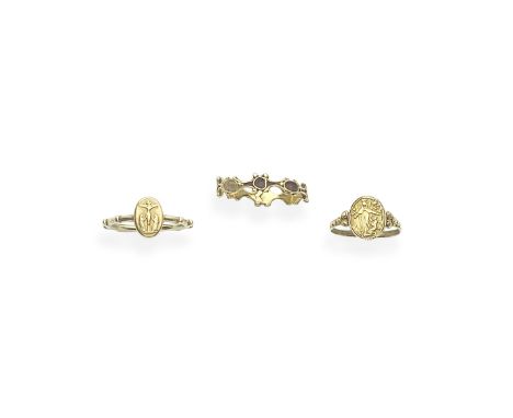 THREE GOLD RELIGIOUS RINGS, 18TH-19TH CENTURY1st: A decade ring depicting Christ on the Cross, 2nd: The central plaque depict
