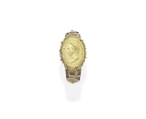 GOLD AND TURQUOISE MEDALLION RING, CIRCA 1820The bezel designed as an oval compartment, the lid depicting the bust of Louis A