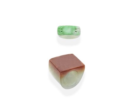 TWO JADEITE ARCHER RINGS, 20TH CENTURY1st: The ring of square profile carved from jadeite fading from orange to light green, 