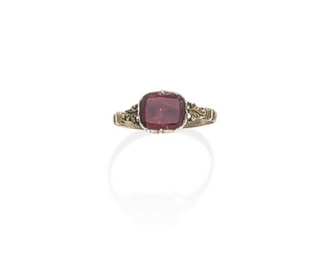 GARNET RING, FIRST QUARTER OF THE 19TH CENTURYThe cushion-shaped garnet in a foiled, closed-back and pinched-collet setting, 