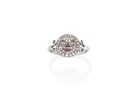 RUBY AND DIAMOND RING, 20TH CENTURY COMPOSITEDepicting a face, set throughout with rose-cut diamonds with ruby accents, betwe