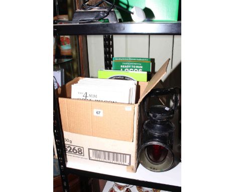 Two boxes of railway books and railway lamp.