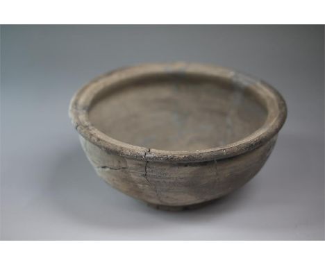 A ceramic grey ware bowl with rolled rim and body rounding to the base ring. Base with inked excavation reference. Excavated 