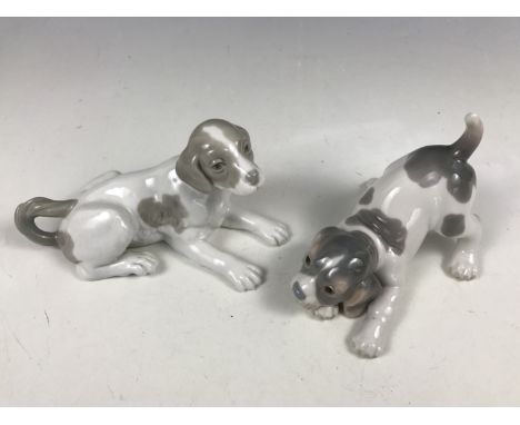 A Lladro figurine of a puppy, together with one other Nao puppy