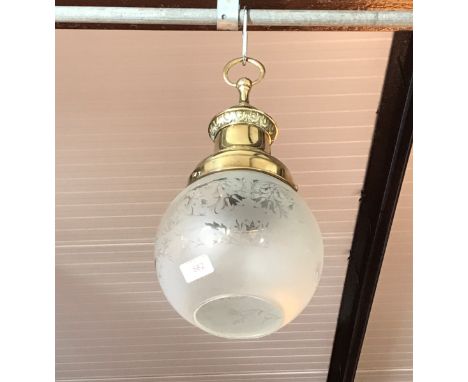 An early 20th Century pendant brass ceiling light with etched glass shade