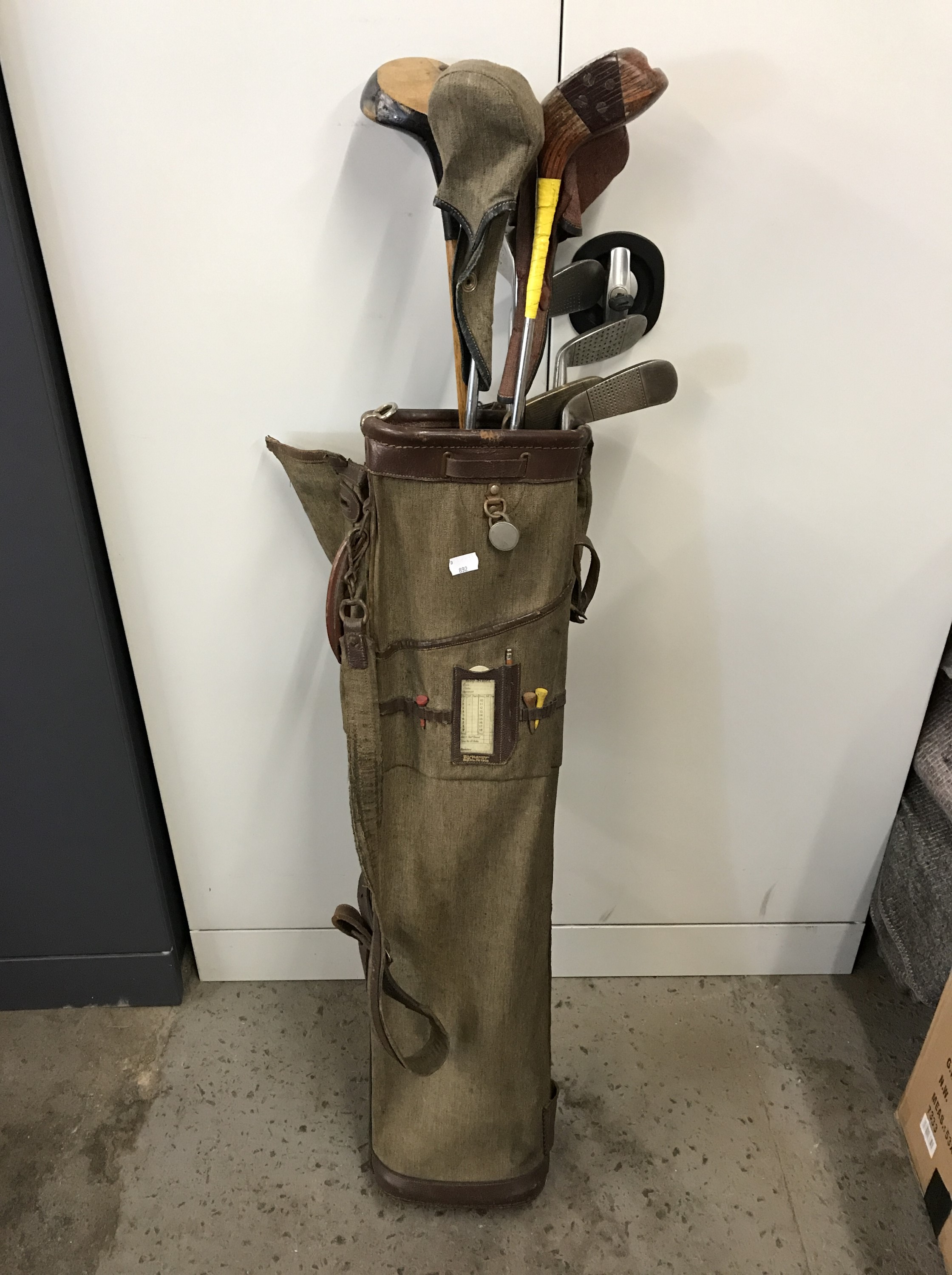 A vintage golf bag with clubs