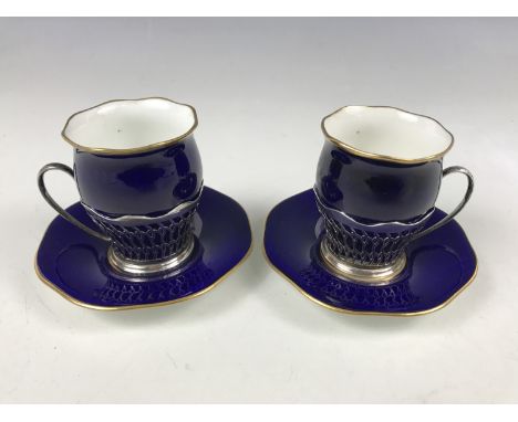 Two silver mounted Coalport cups with saucers