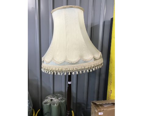 A turned and carved wooden standard lamp