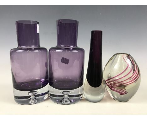 A pair of post-War studio glass amethyst cylindrical bottle vases, having tiered-bases, together with two other vases