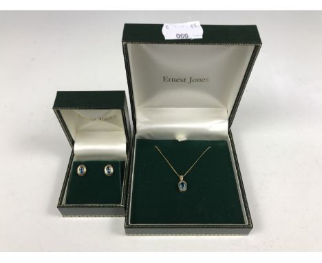 A contemporary yellow-metal pendant necklace and stud earring set retailed by Ernest Jones, each item being collet set with a