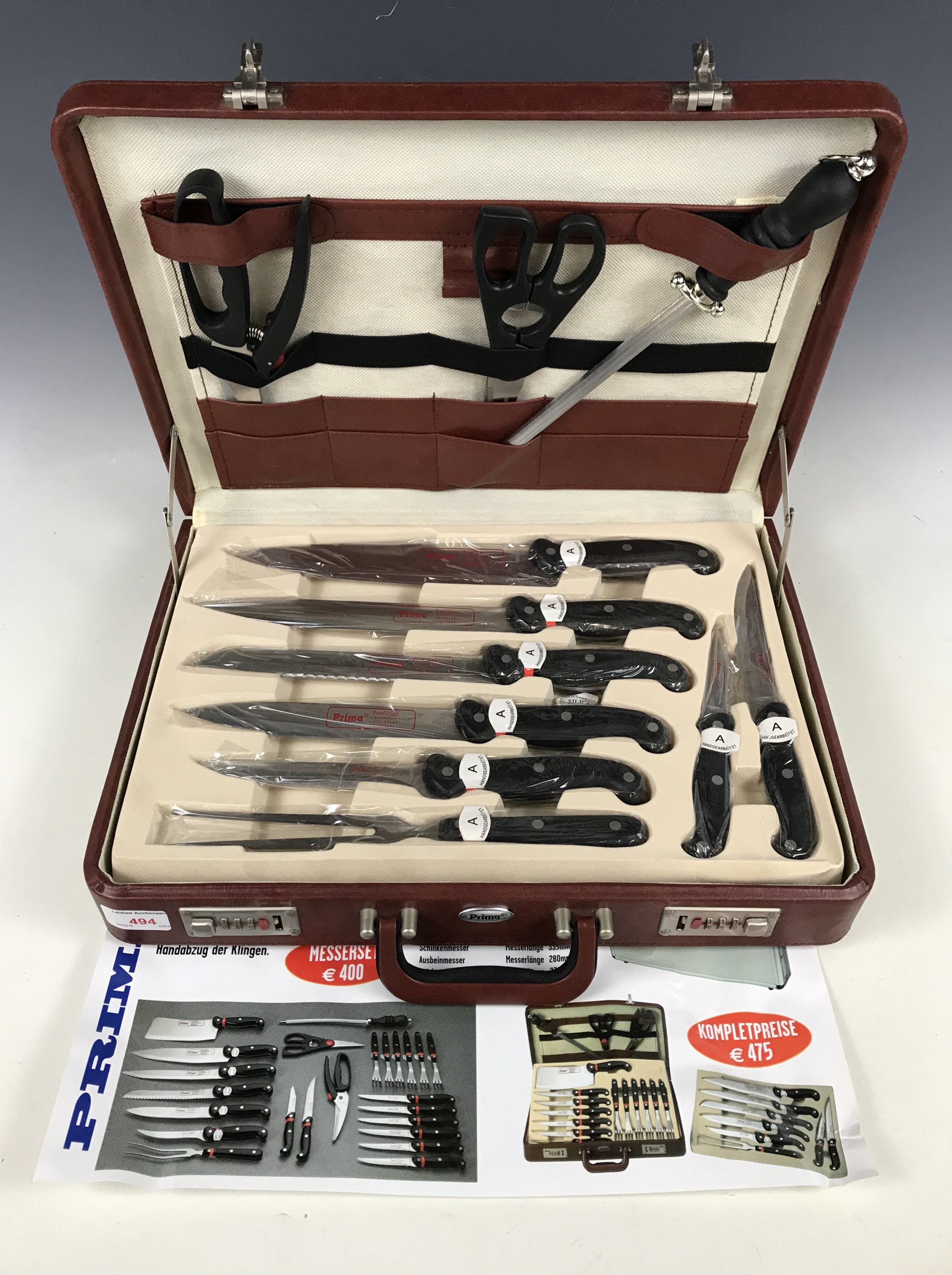 A Prima cased knife and meat cleaver set including steak knives and forks