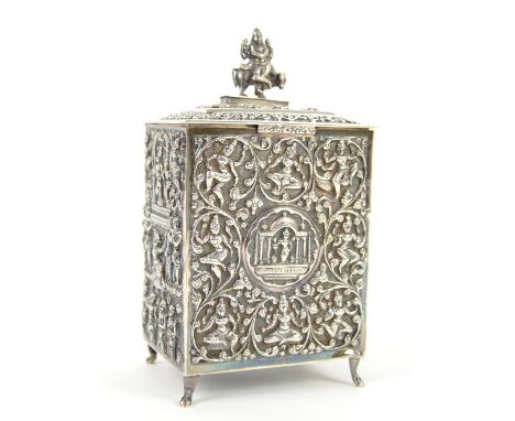 Indian white metal tea caddy with embossed scrolling and figural decoration, on four shaped feet, 17cm high, 345 gr. .       