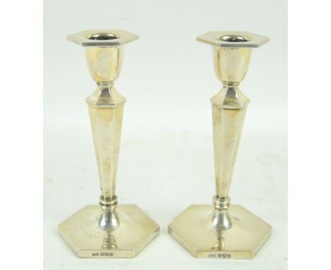 Elizabeth II pair of silver hexagonal form candlesticks, by Walker &amp; Hall, Sheffield 1964, with filled bases, 16 cm high 