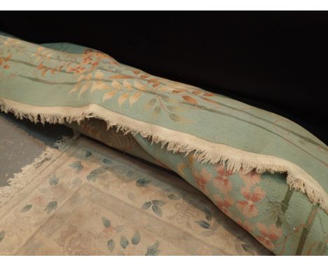 Thick pile fringed Chinese carpet with designs of flora and bamboo against a green ground approximately 11' x 9'