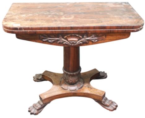 A 19th century rosewood veneered fold over card table on tapering cylindrical column on quadrupedal base with paw feet, 75cm 