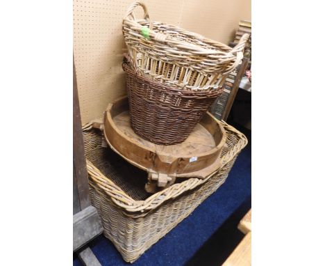 A lot comprising a large 20th century wicker laundry hamper, two smaller wicker laundry baskets and a wooden circular tray (4