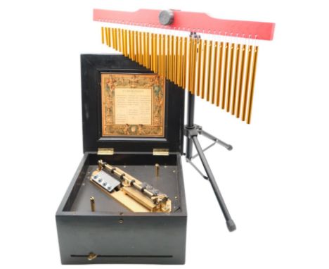 A 19th Century double-comb music box Symphonion, in a wooden case with a patterned design on the lid, and an adjustable 36-to