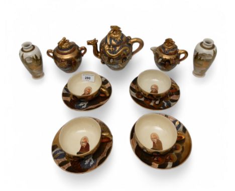 A Japanese Satsuma tea service, decorated with dragons and arhats, and a pair of Satsuma vases decorated with landscape scene