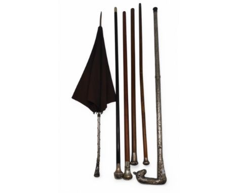 A rosewood walking cane with Birmingham silver top and horn ferule, two further silver-topped canes, a parasol with wire-woun