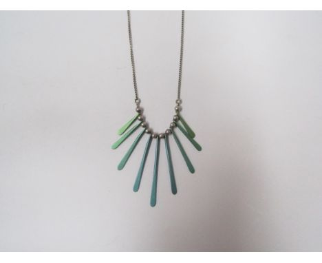 A 1980's white metal graduated paddle necklace with blue and green titanium coated paddles 