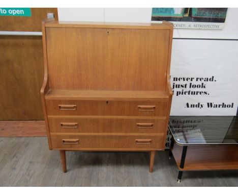 A Danish oak finish bureau, single shelf interior, three drawers below. Raised on tapering legs. 85cm x 44cm x 114cm high.