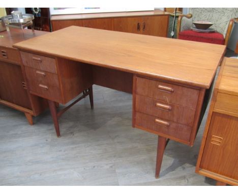 A Danish teak twin pedestal desk with six drawers, open shelf back, raised on tapering legs, 120cm x 60cm x 74cm 