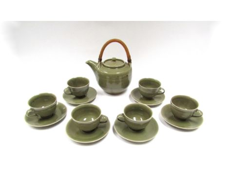 A Crowan Pottery (Harry &amp; May Davis) studio pottery teapot with olive green glaze, matching six cups and saucers. (Some a