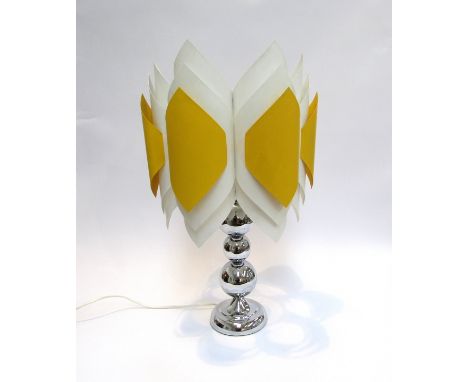 A chromed metal lamp base with a white and yellow plastic shade.