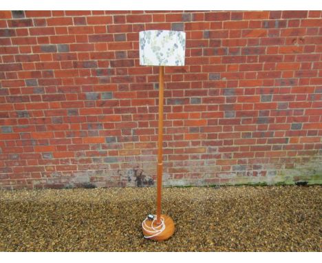 A teak standard lamp