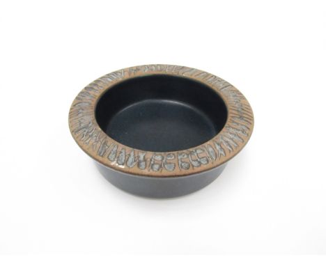 Lisa Larson for Gustavsberg - A stoneware bowl in blue with impressed motifs to flattened rim. 15cm diameter x 5cm high