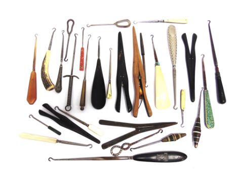 A COLLECTION OF VARIOUS BUTTON HOOKS  in assorted materials, with some glove stretchers also