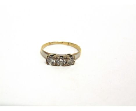 A THREE STONE DIAMOND RING marks obscured, the graduated brilliant cuts totalling approximately 0.45 carats, finger size M, 2