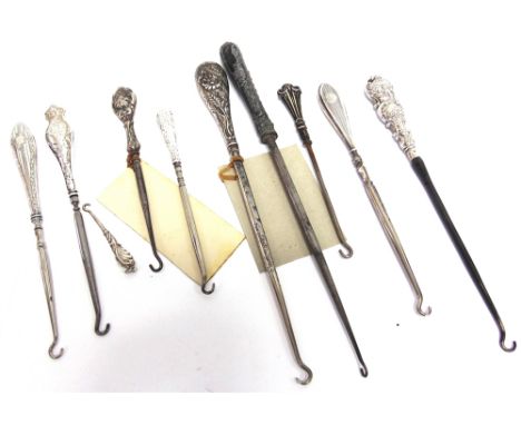 A COLLECTION OF TEN SILVER AND SILVER COLOURED BUTTON HOOKS 