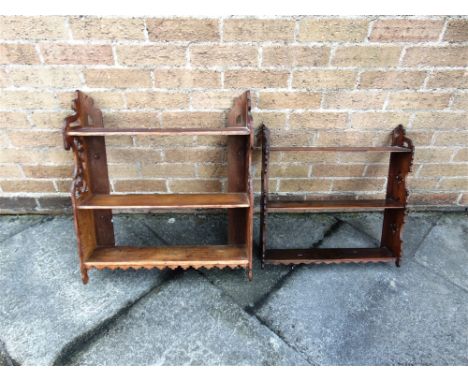 AN OAK HANGING WALL SHELF  the sides with open fret cut decoration, 58cm wide 15cm deep 66cm high, and a similar mahogany exa