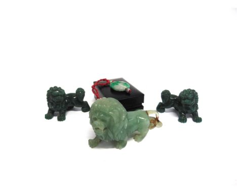A CARVED JADE FIGURE OF A LION  12cm long, similar pair of Dogs of Fo, and a pendant