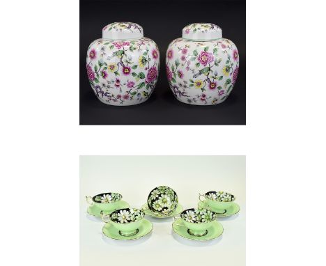 Paragon Fine China Set of Five Tea Cups and Saucers, the interior of the light green cups decorated with daisies on a black g