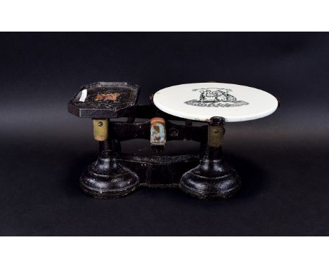 Cast Iron Kitchen Scales Antique scales with ceramic weighing plate finished in black and gilt paint.