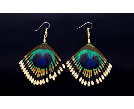 A Pair Of Unique And Intricate Handmade Peacock Feather Earrings Attractive wired drop earrings fashioned from the eye of pea